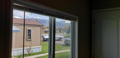 A view of the mountains from a window in a mobile home.