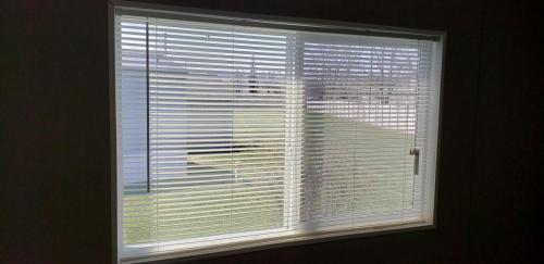 A window in a room with blinds on it.