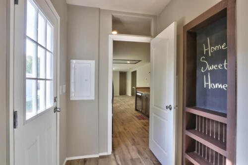 A hallway in a home with a chalkboard.