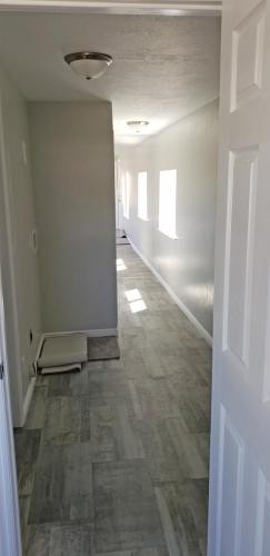 A hallway with a door leading into a room.